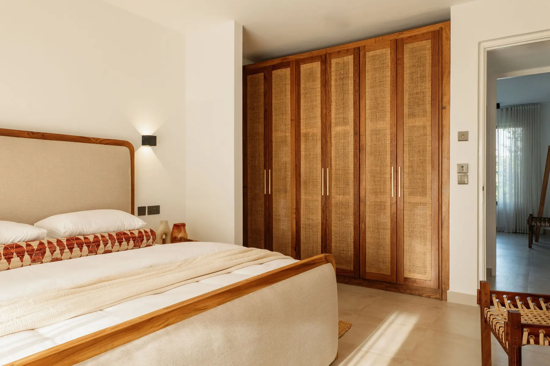 Bedroom with wooden bed and fitted wardrobe