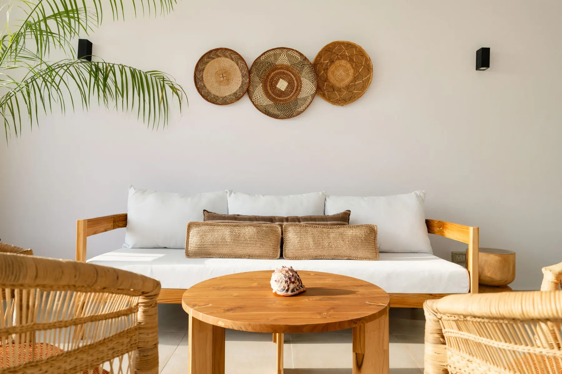 Living area with wooden furniture and woven wall decoration